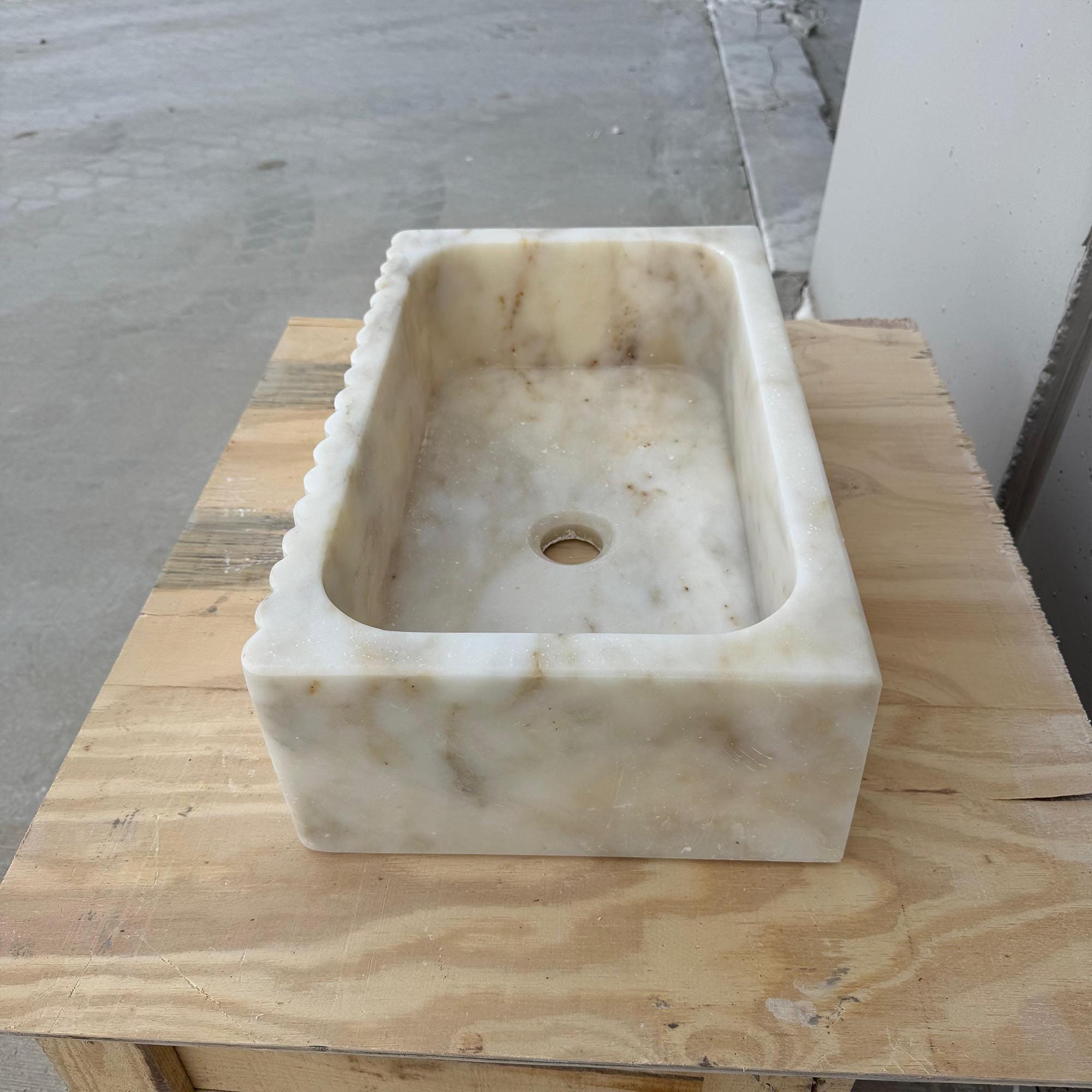 High-end stone bathroom basin made from Calacatta Gold marble.