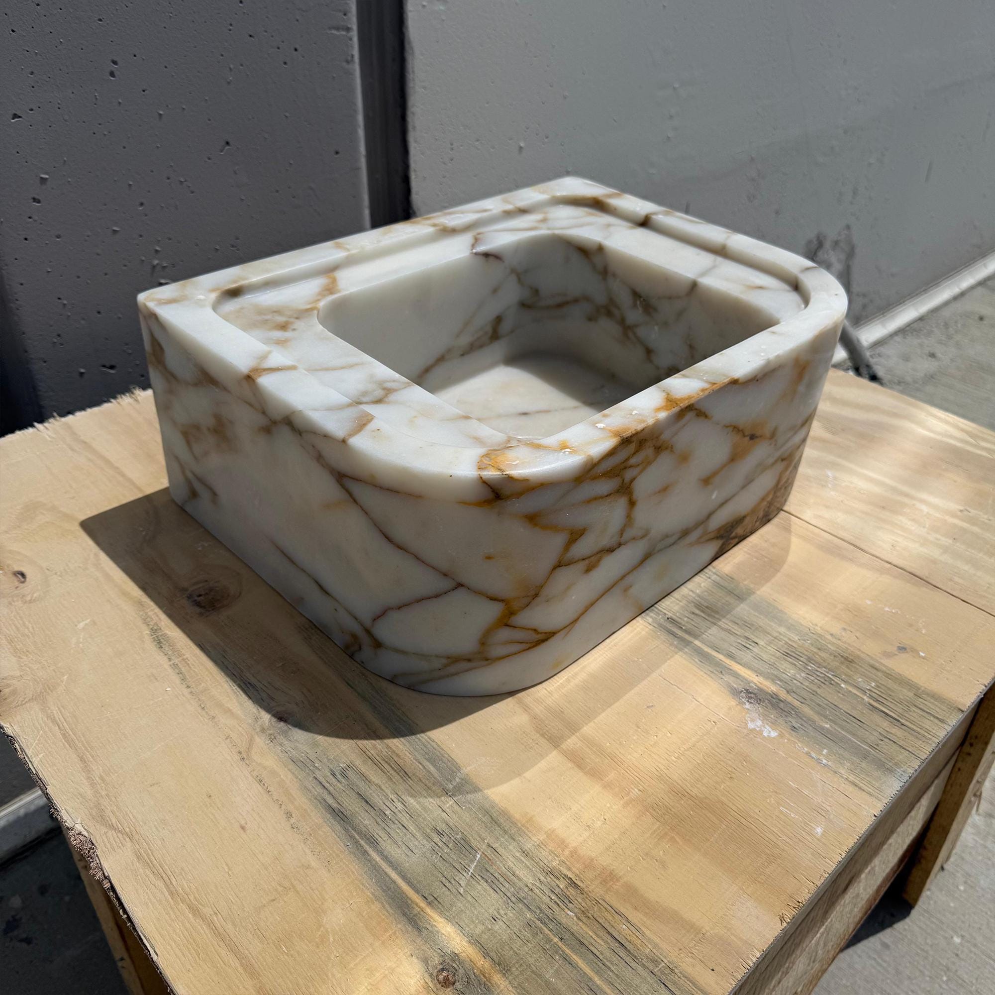 Premium marble sink with soft curves and golden natural patterns