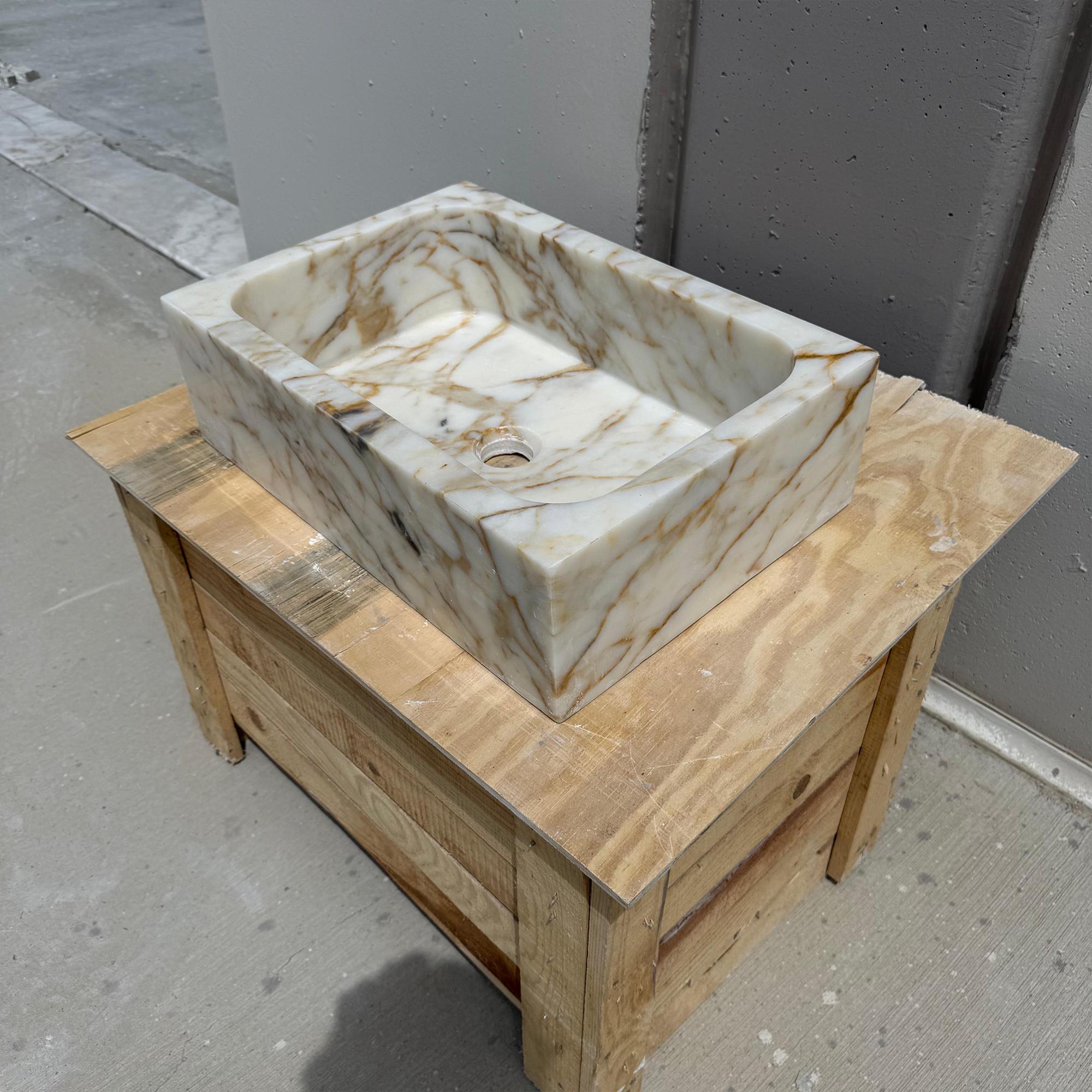 Designer stone vanity basin in a sharp-edged rectangular form