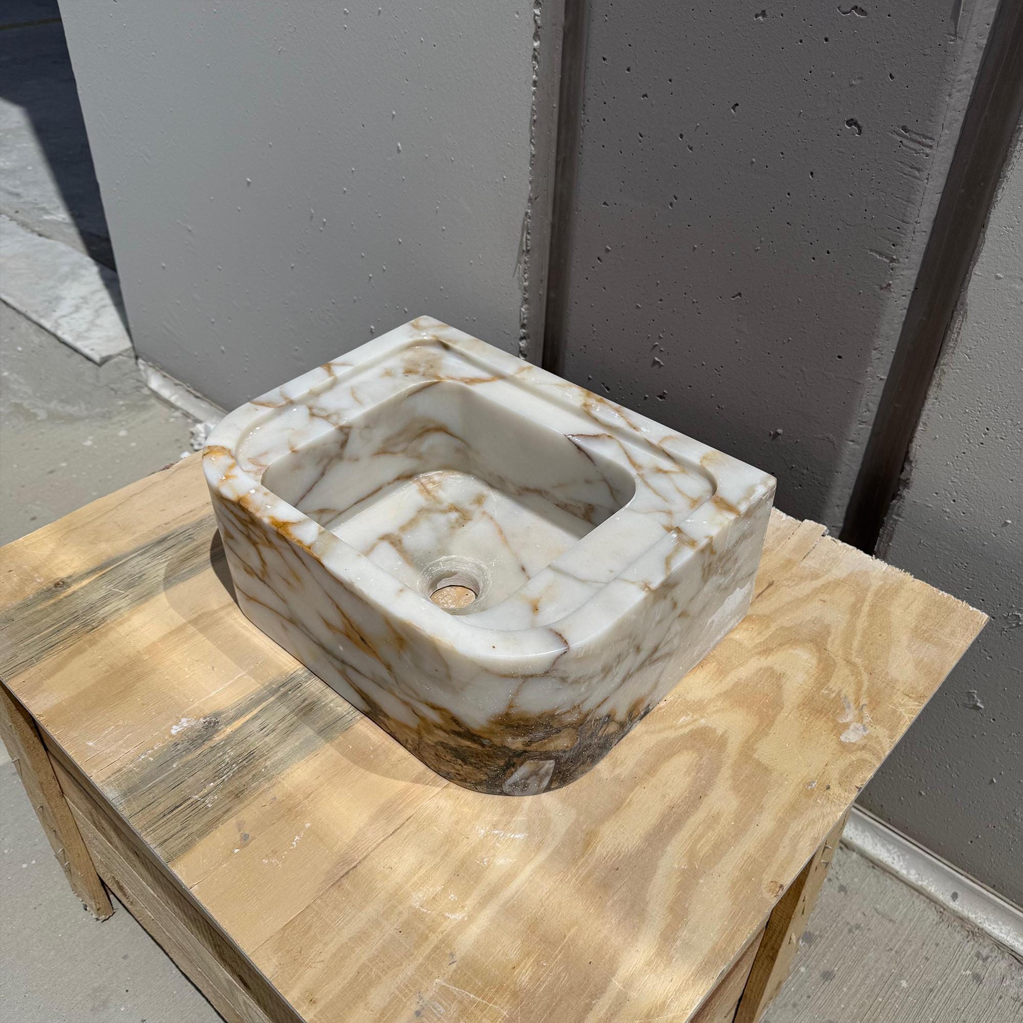 Small luxury marble basin for powder rooms crafted from Calacatta Gold stone