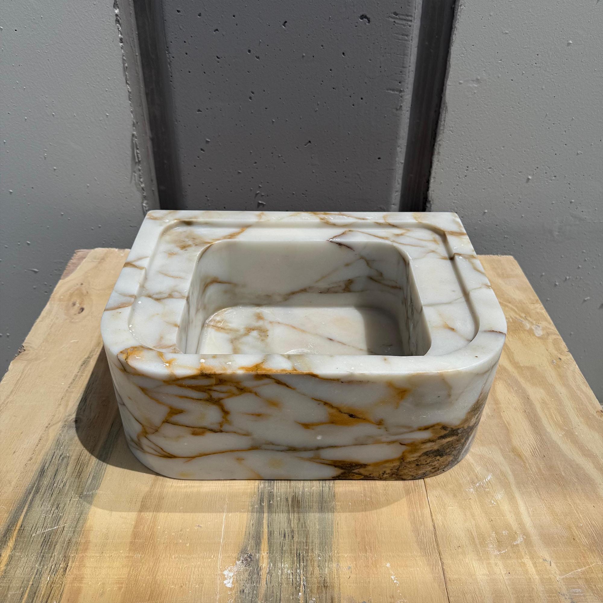 Designer compact stone basin in luxurious Calacatta Gold finish