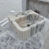 Fluted Calacatta marble sink with triple faucet holes and sculpted basin