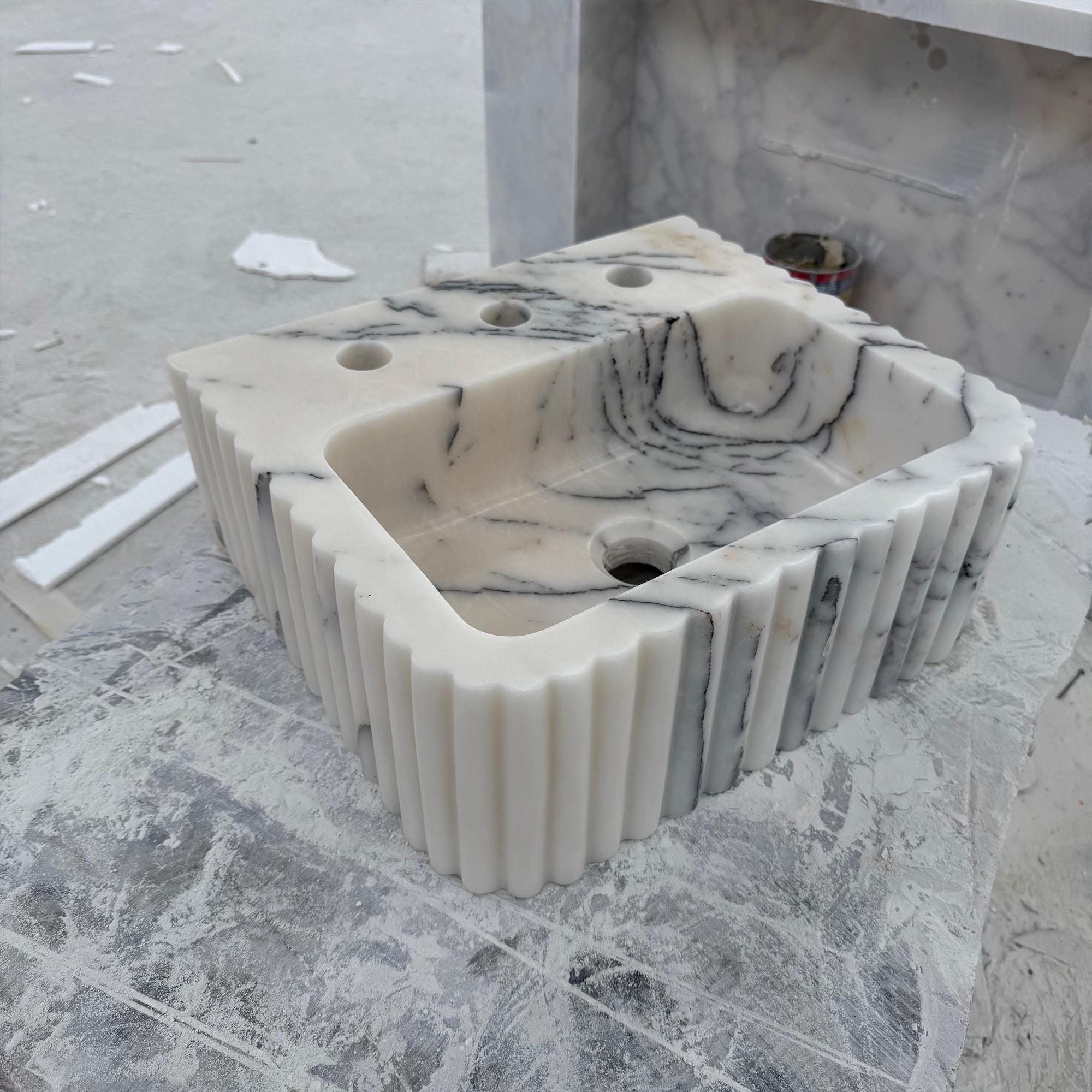 Fluted Calacatta marble sink with triple faucet holes and sculpted basin
