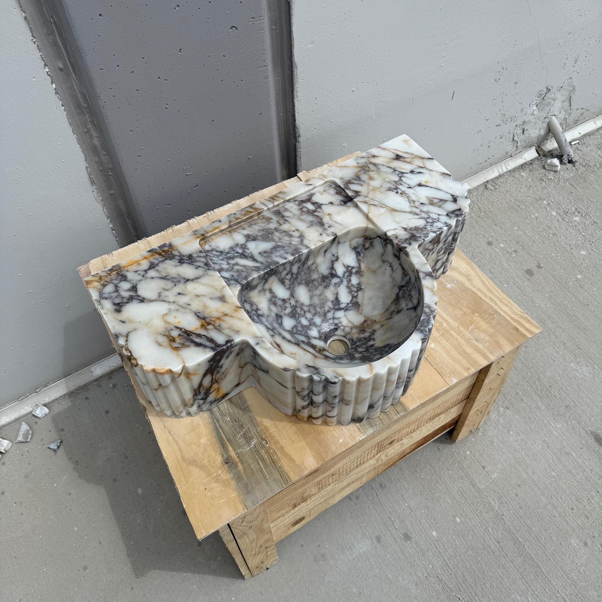 Unique oval marble basin with fluted detailing and premium craftsmanship