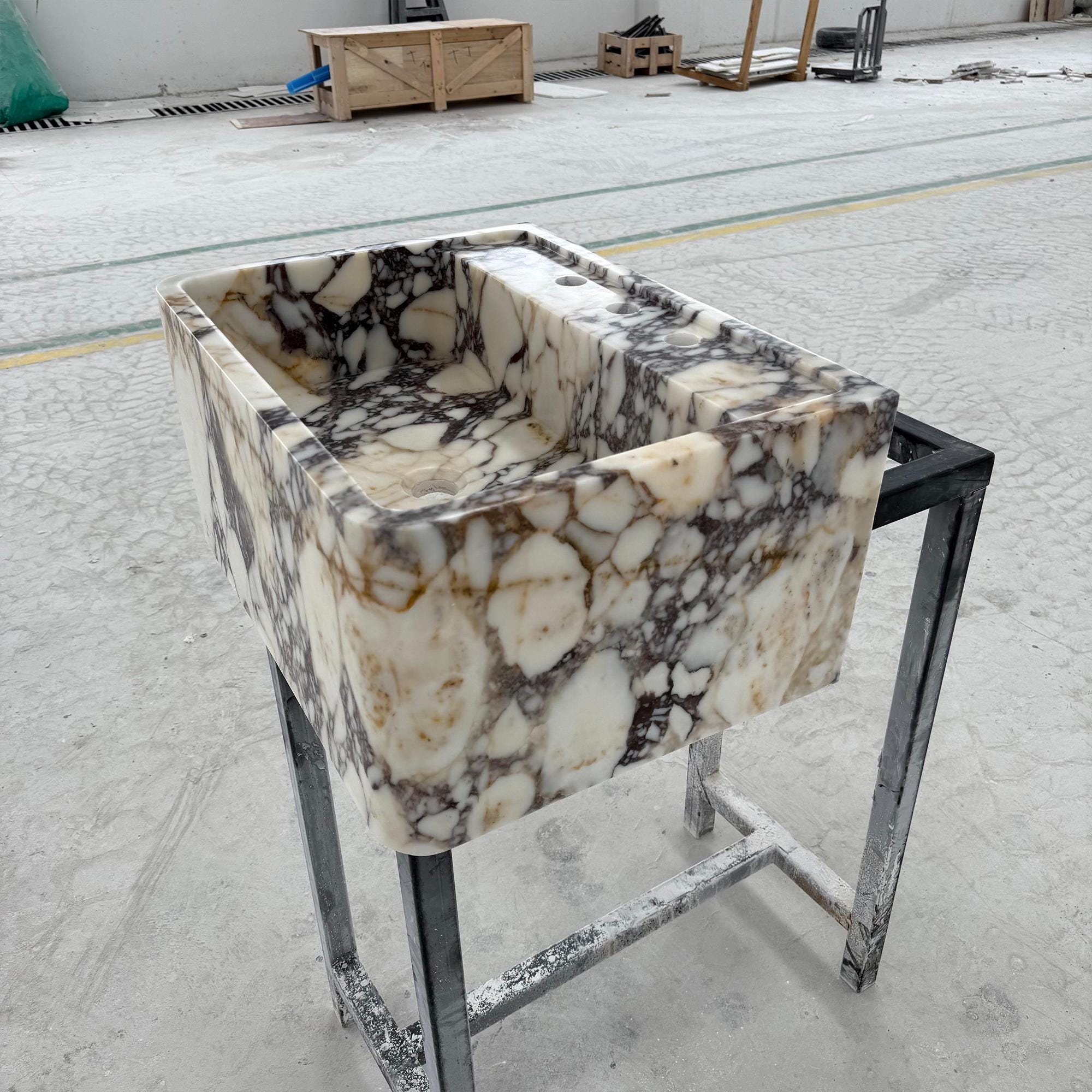 High-end marble sink with moody purple and white veining on pedestal