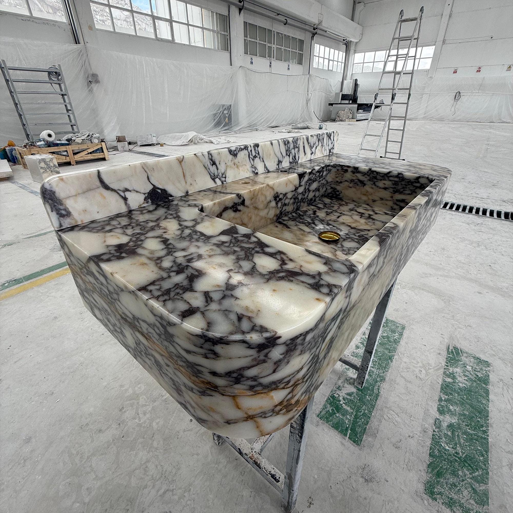 Statement marble sink perfect for luxurious powder rooms and custom interiors.