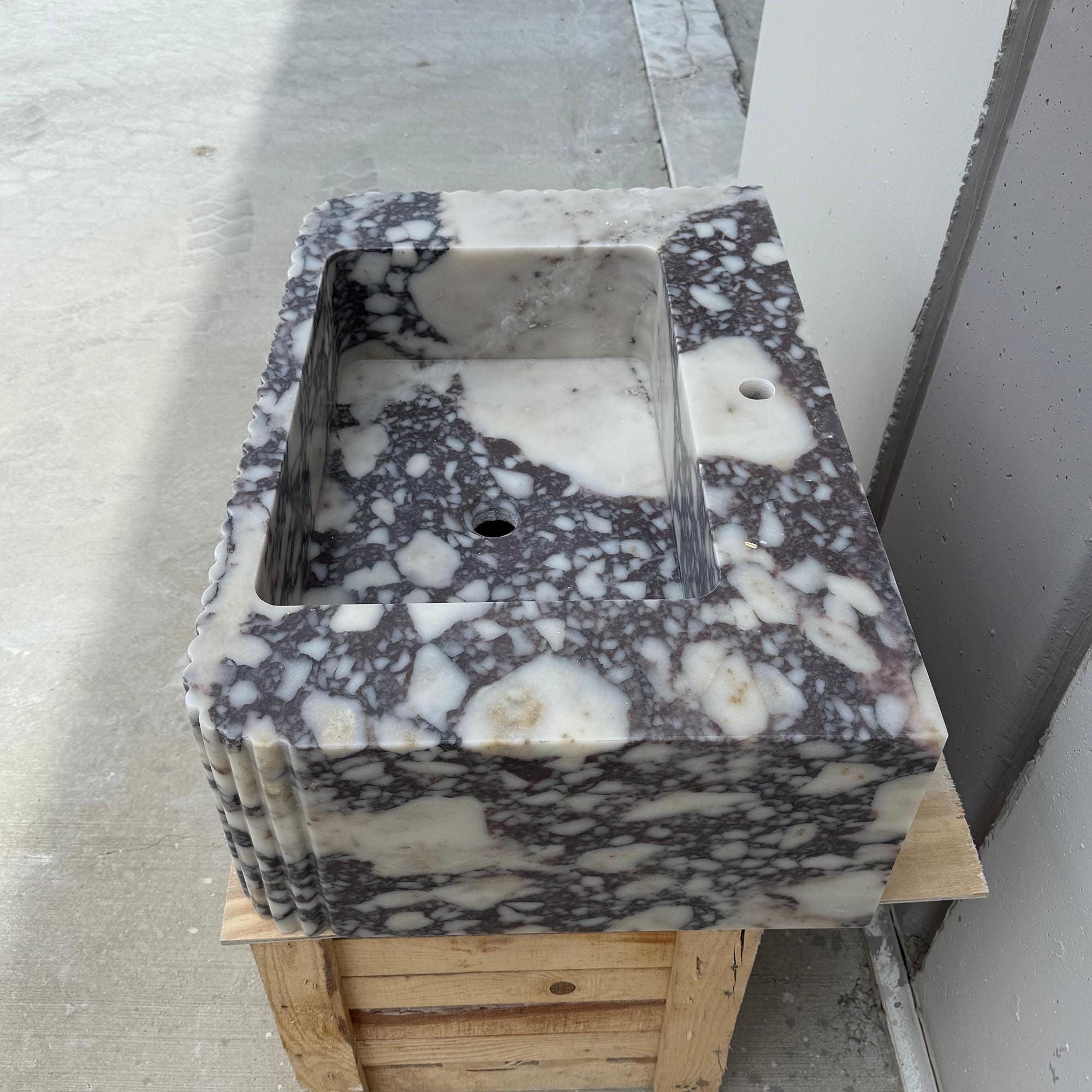Handcrafted rectangular marble sink in dramatic Calacatta Viola stone