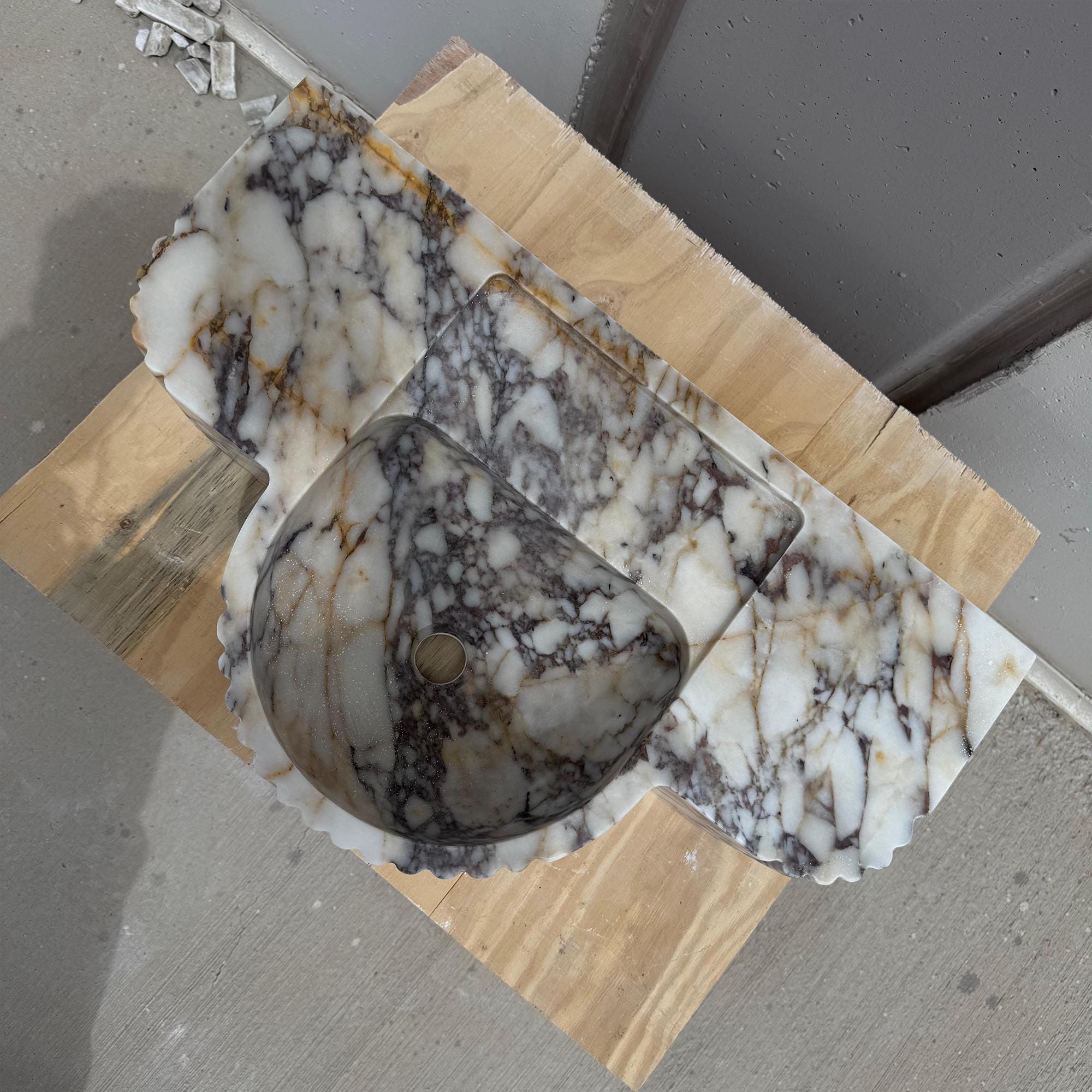 High-end fluted bathroom sink with bold Italian marble texture