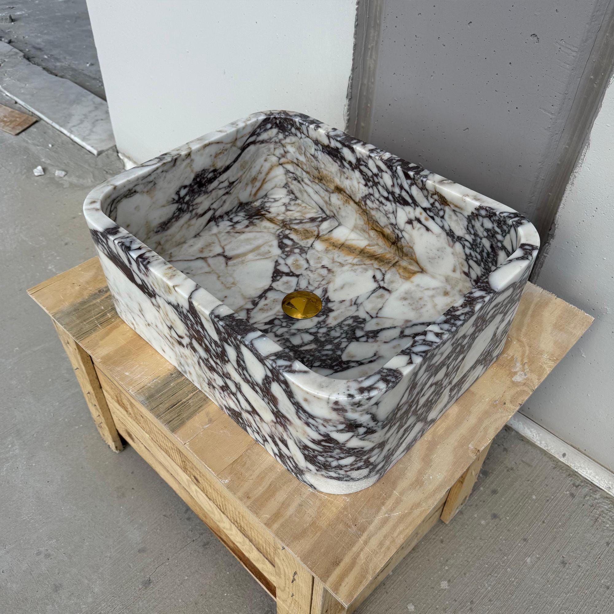 Rounded Calacatta Viola marble sink with soft sculpted edges