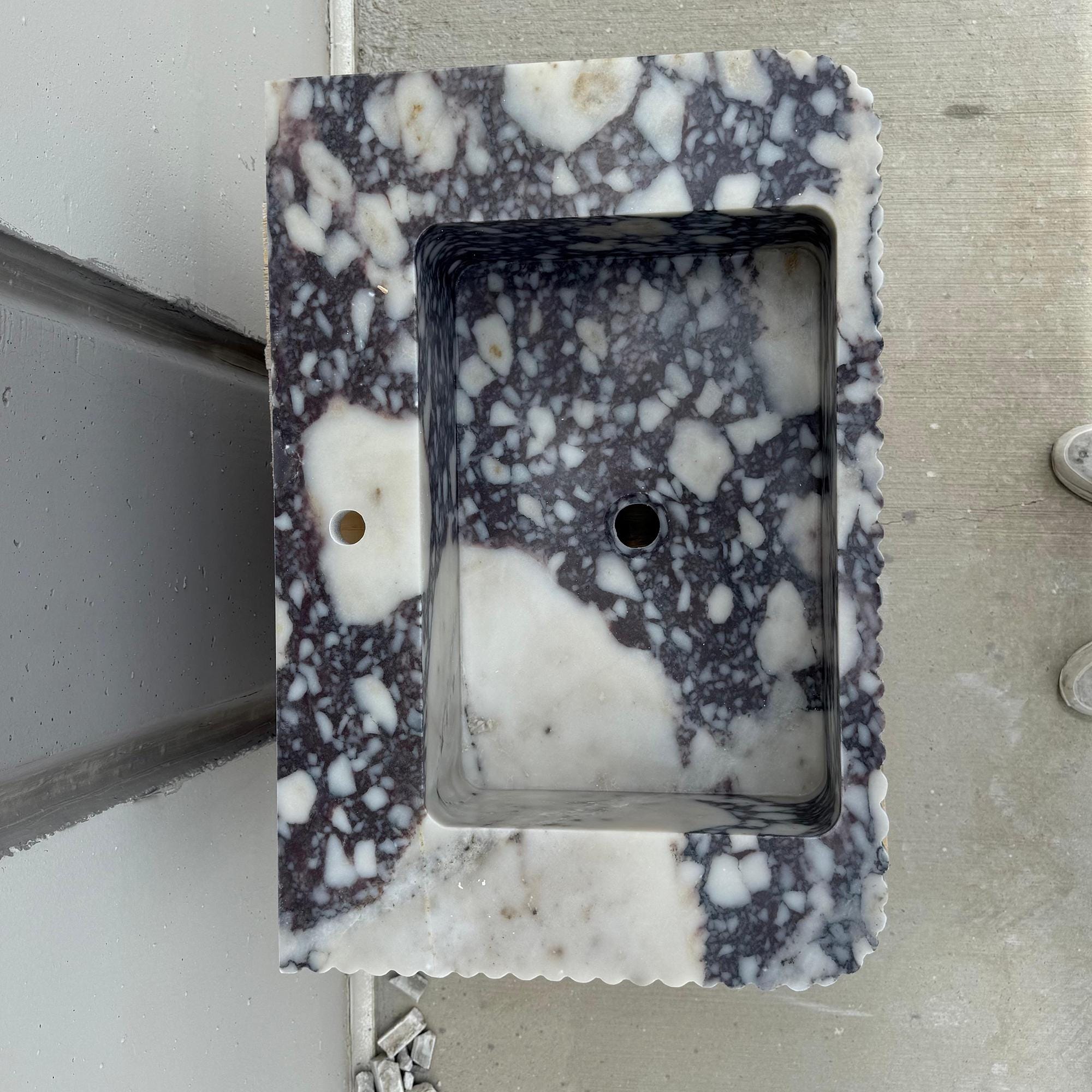 Bold statement marble sink made from Italian Calacatta Viola marble