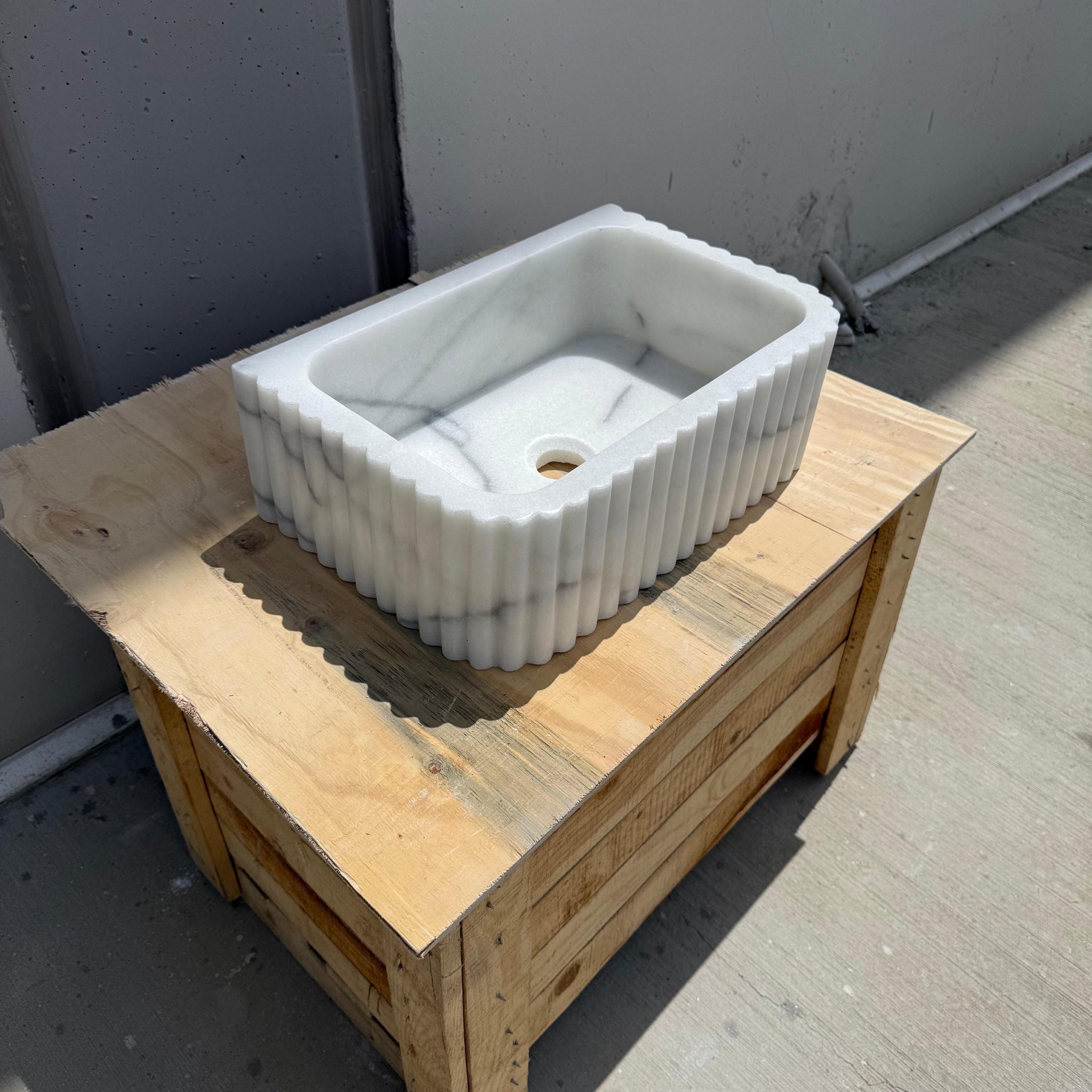 Custom handcrafted Carrara marble sink with minimalist lines