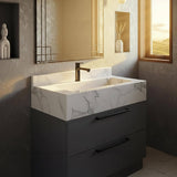 The image shows a Carrara marble vanity sink paired with a matte black cabinet in a modern luxury bathroom.