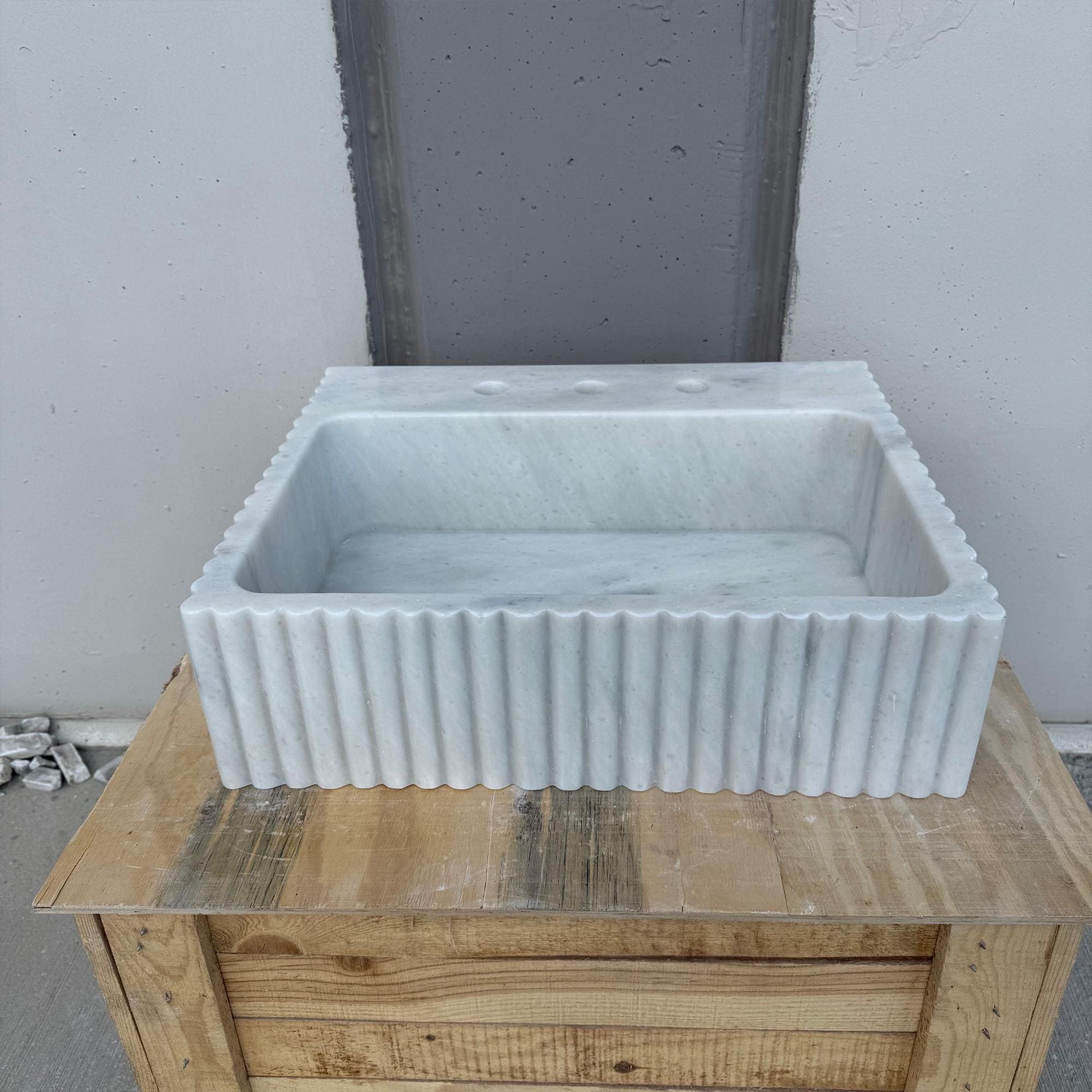 Designer Carrara vanity basin with golden hardware detail