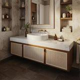 Carrara marble vessel sink on a floating rattan-fronted vanity in a luxury bathroom.