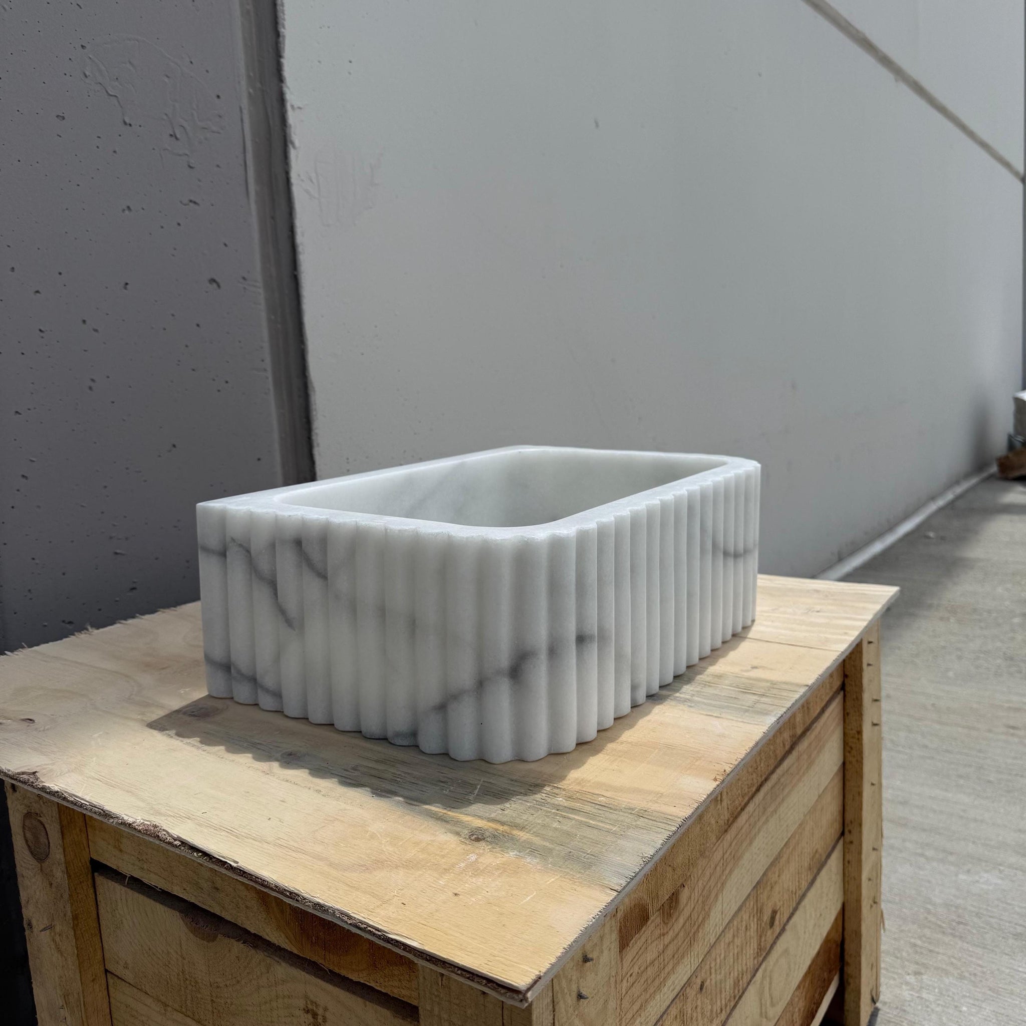 Italian Carrara marble sink with modern fluted pattern