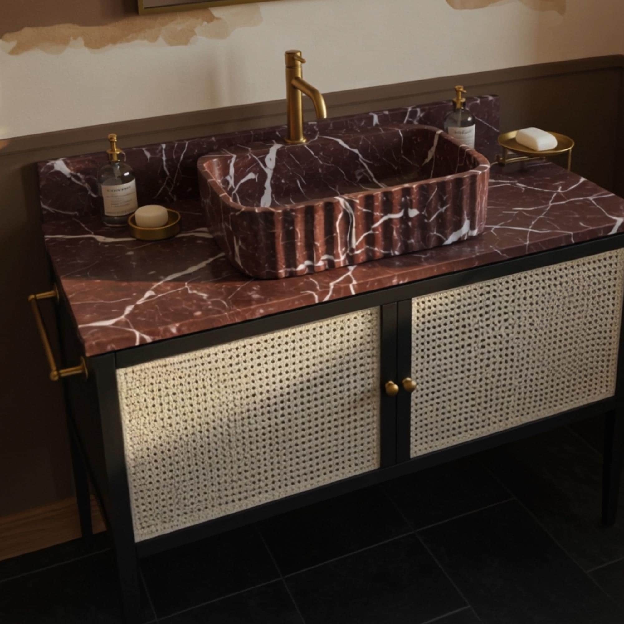 Fluted red stone sink on dark wood and rattan cabinet