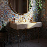 A handcrafted travertine marble sink with elegant brass legs.