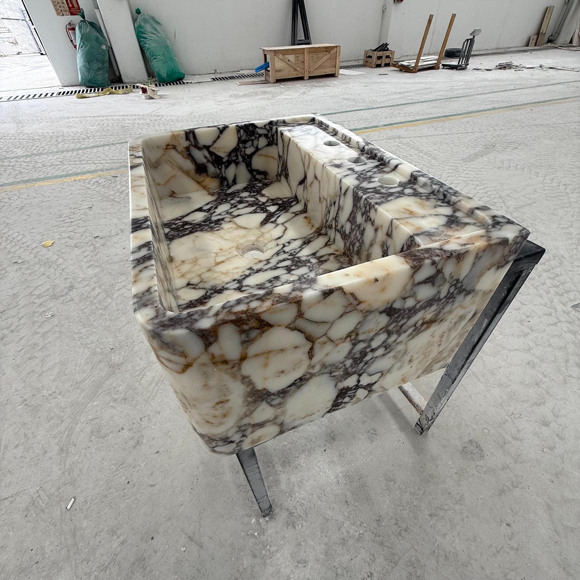 Designer bathroom sink with built-in counter in premium Viola marble