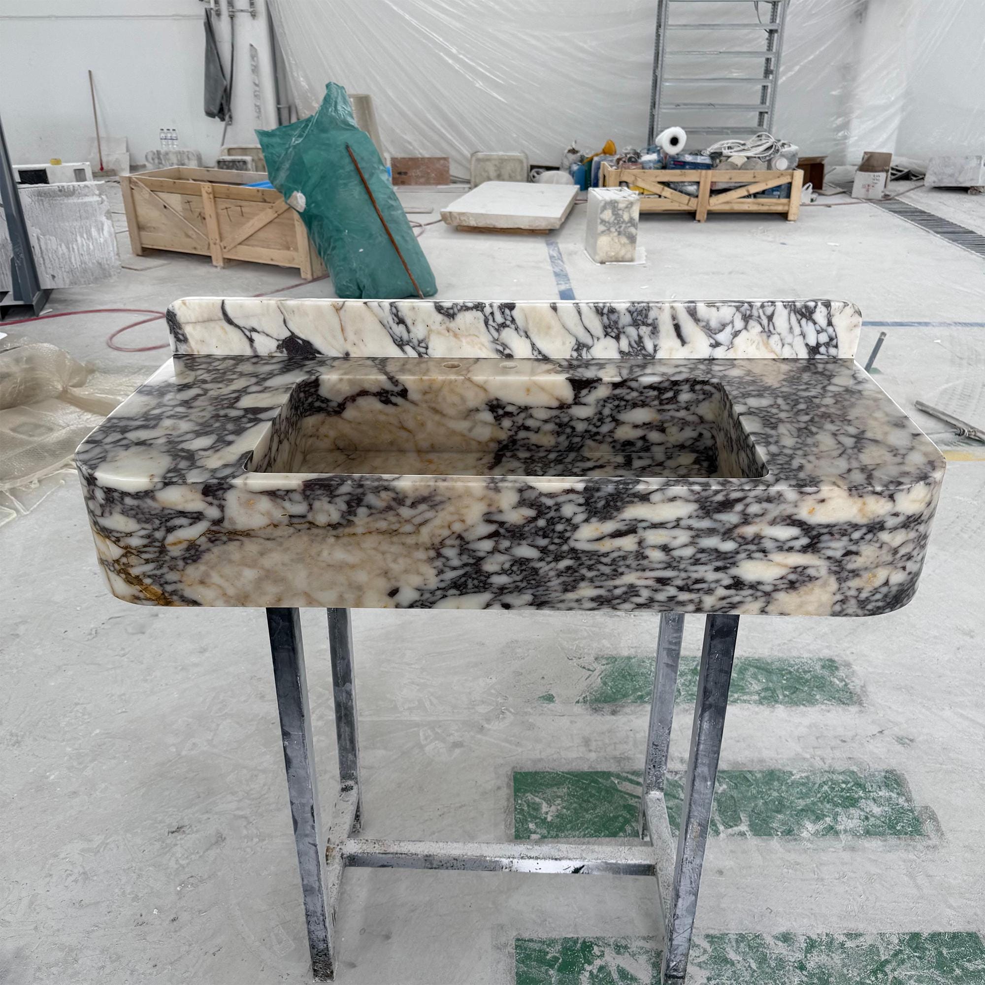 Elegant marble vanity sink with deep veining and a smooth polished finish.