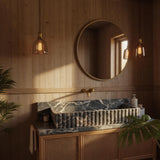 A fluted Picasso marble sink with bold veining sits atop a cane wood vanity in a luxury bathroom interior.