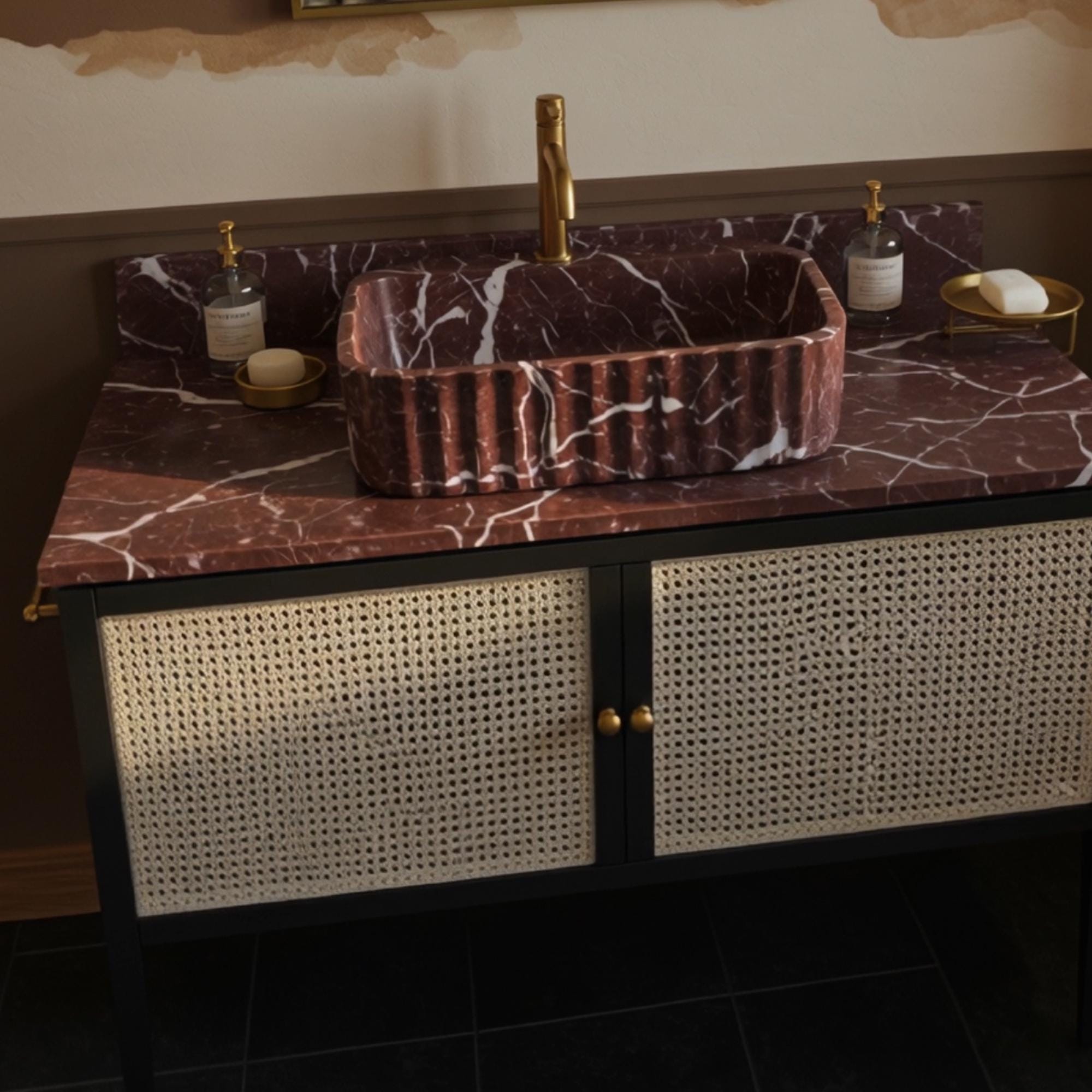 Designer red marble vessel sink with brass fixtures