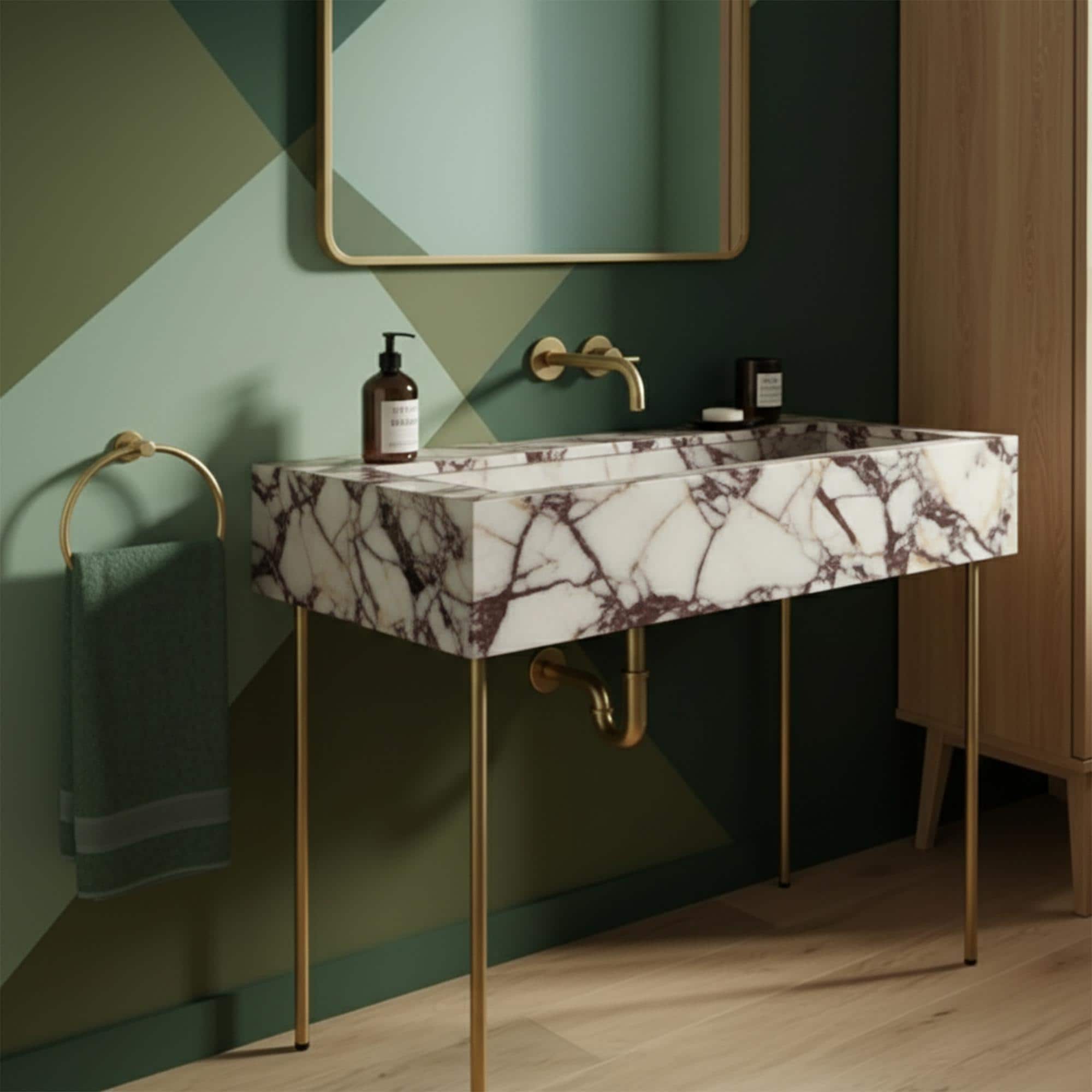 Calacatta Amber Viola marble console sink with brass legs and wall-mounted faucet