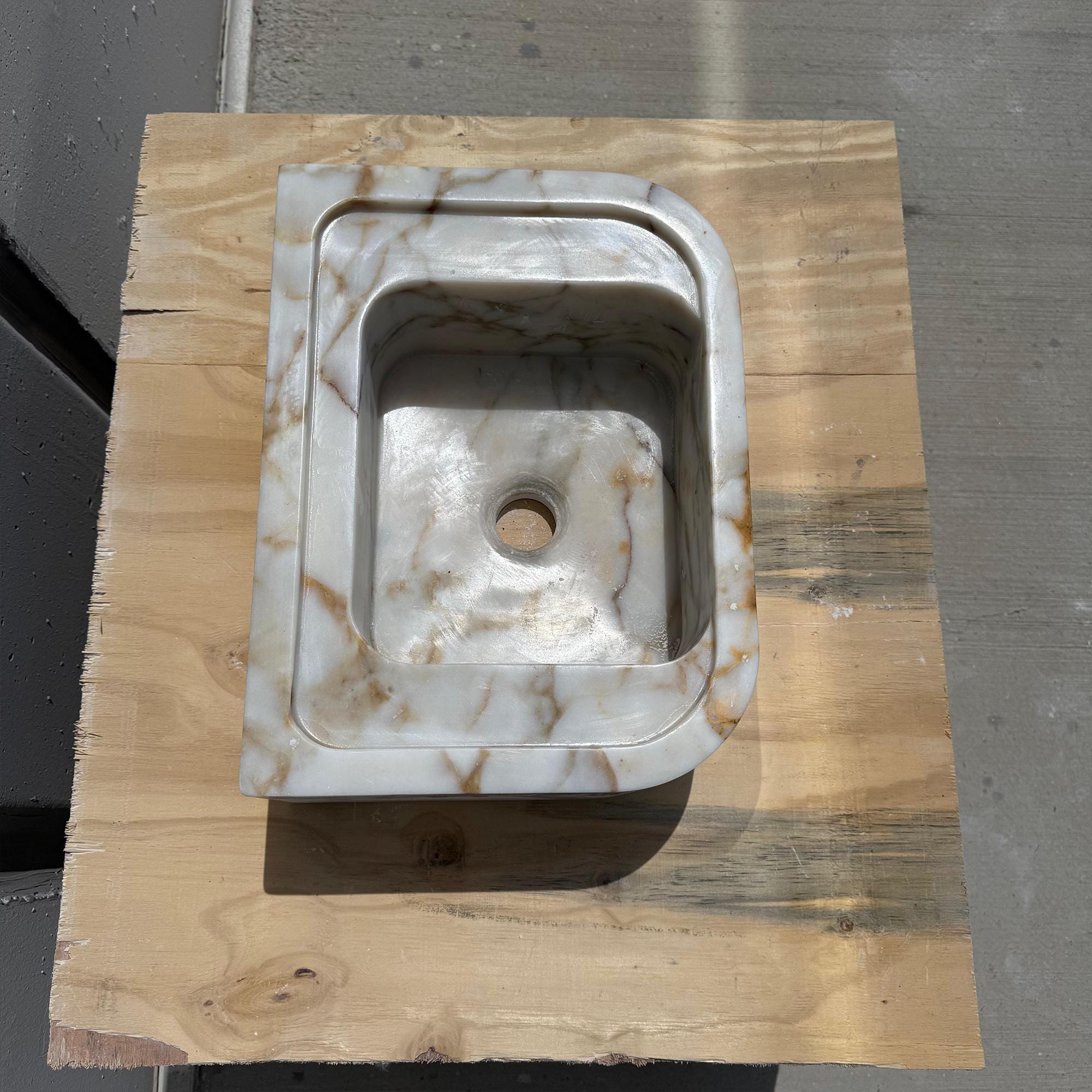 Elegant compact bathroom sink in oval shape and Italian marble