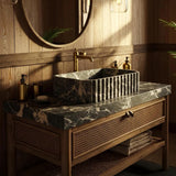 A fluted Picasso marble sink sits on a rattan-front wooden vanity in a luxury bathroom setting.