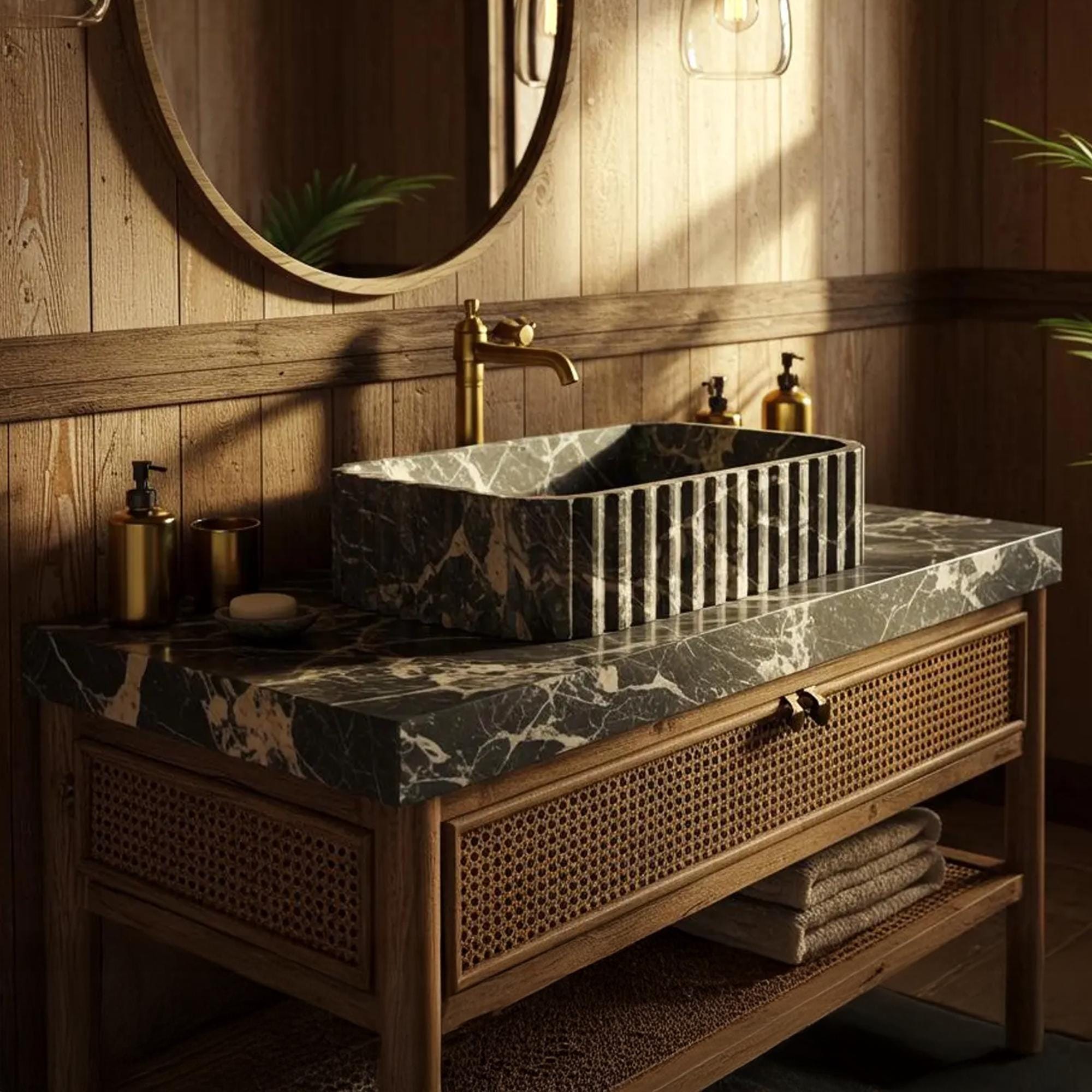 A fluted Picasso marble sink sits on a rattan-front wooden vanity in a luxury bathroom setting.