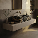 Luxury bathroom interior featuring a handcrafted Picasso marble basin with a textured finish and brushed gold faucet.