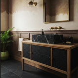 Black marble vessel sink on walnut wood vanity