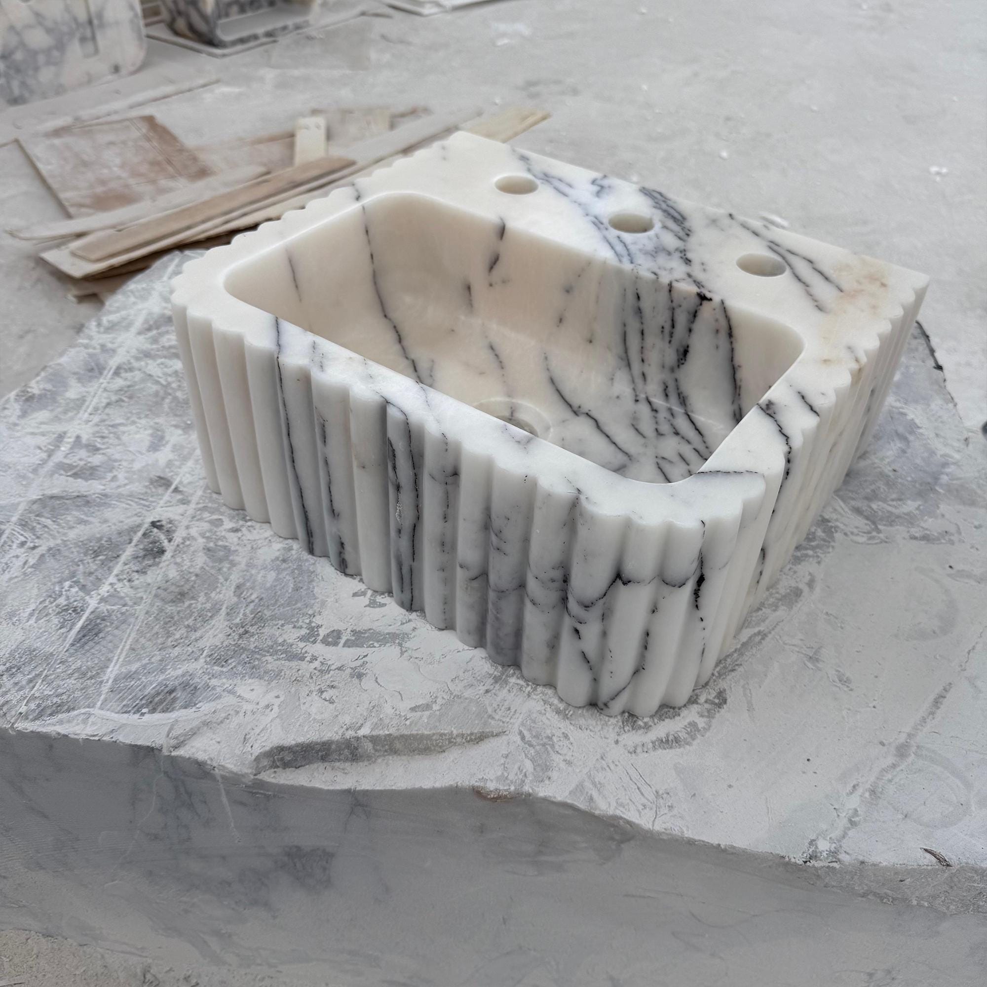 Italian marble fluted sink on workshop surface during fabrication