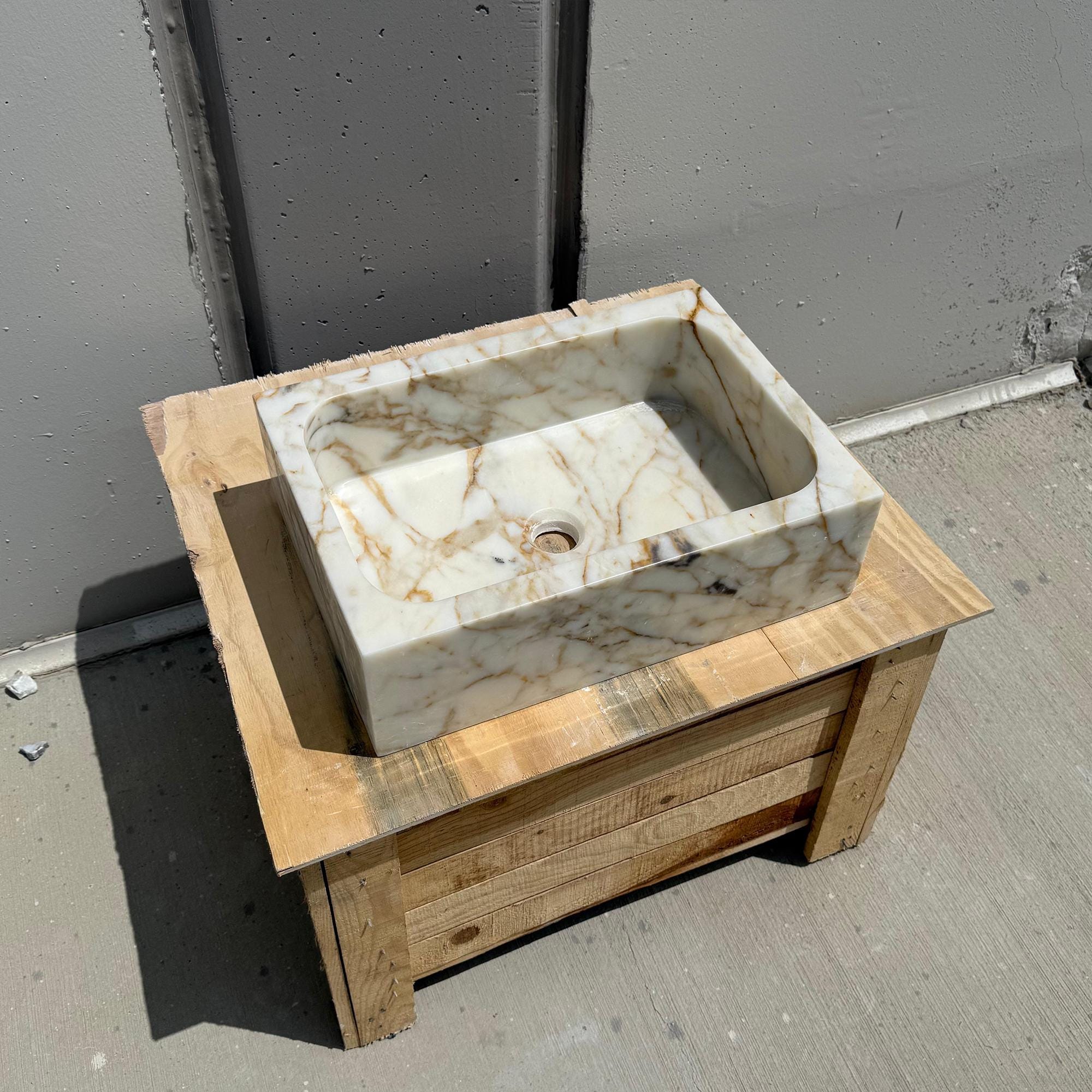 Bold natural marble sink with warm golden veins and flat surface