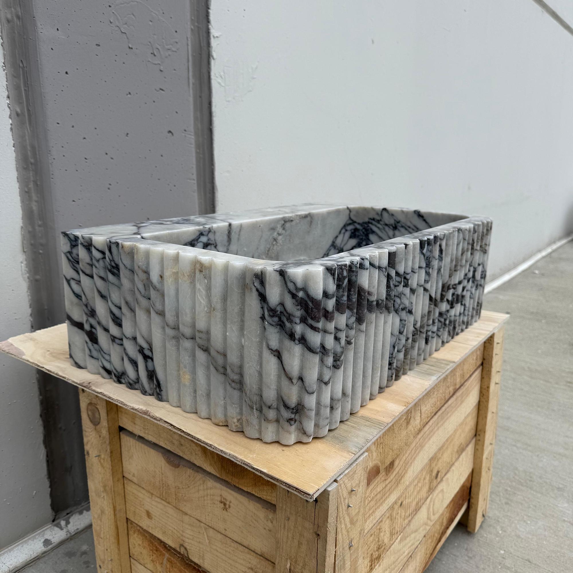 This handcrafted Calacatta Viola sink combines artistic form with natural elegance.