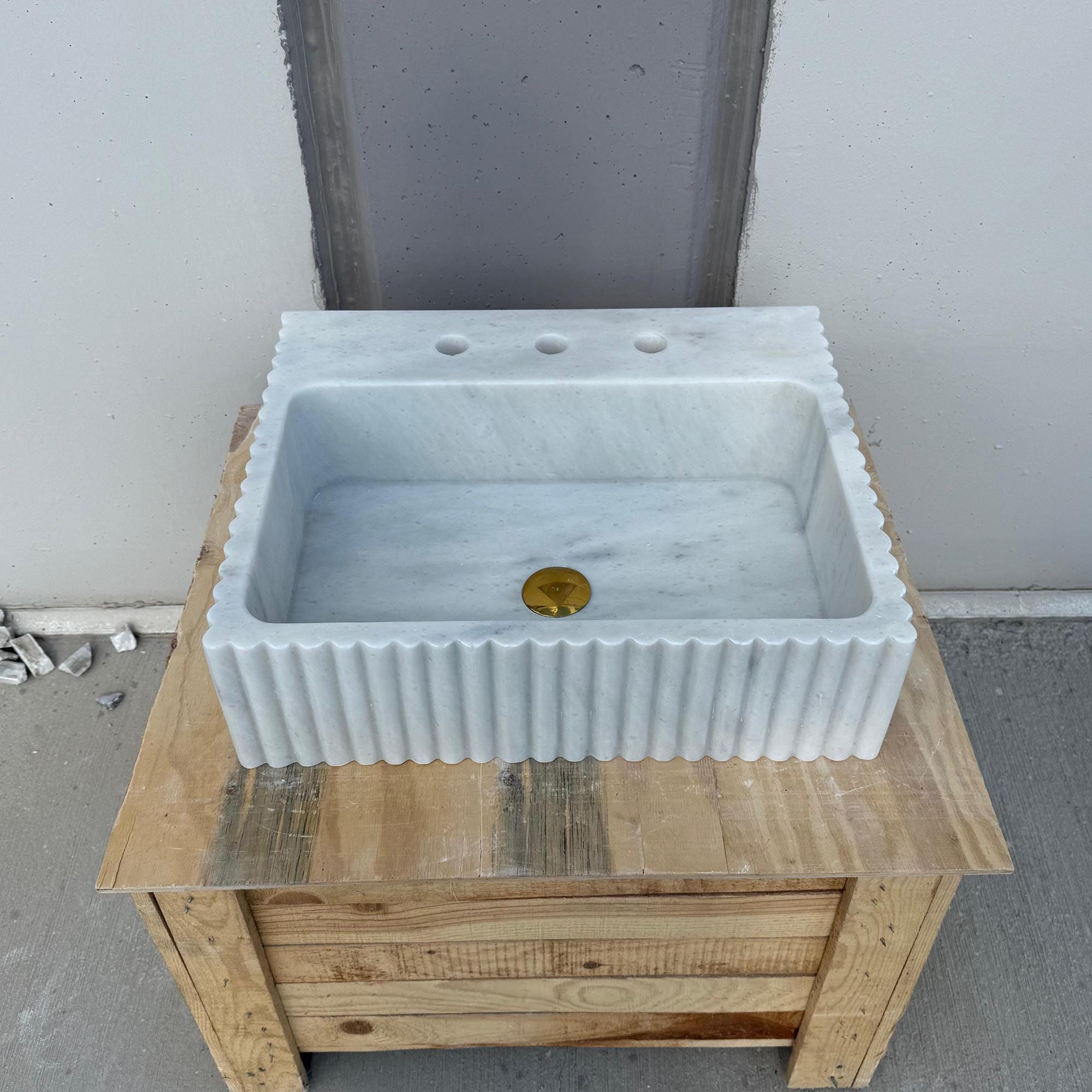 Handcrafted fluted marble sink in polished white stone