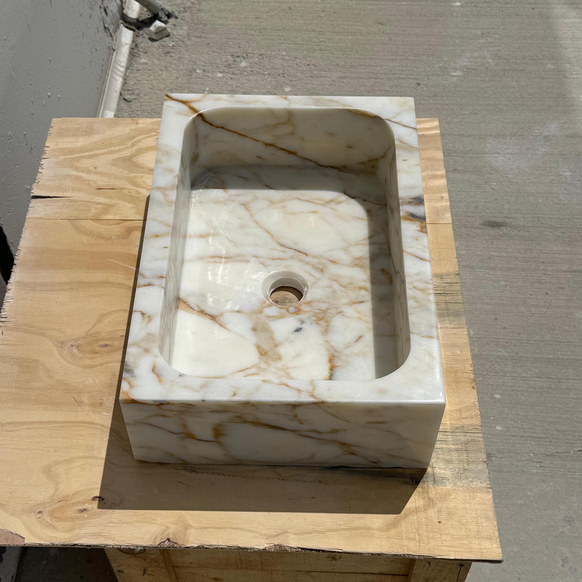 Small luxury bathroom sink made from Italian Calacatta Gold marble